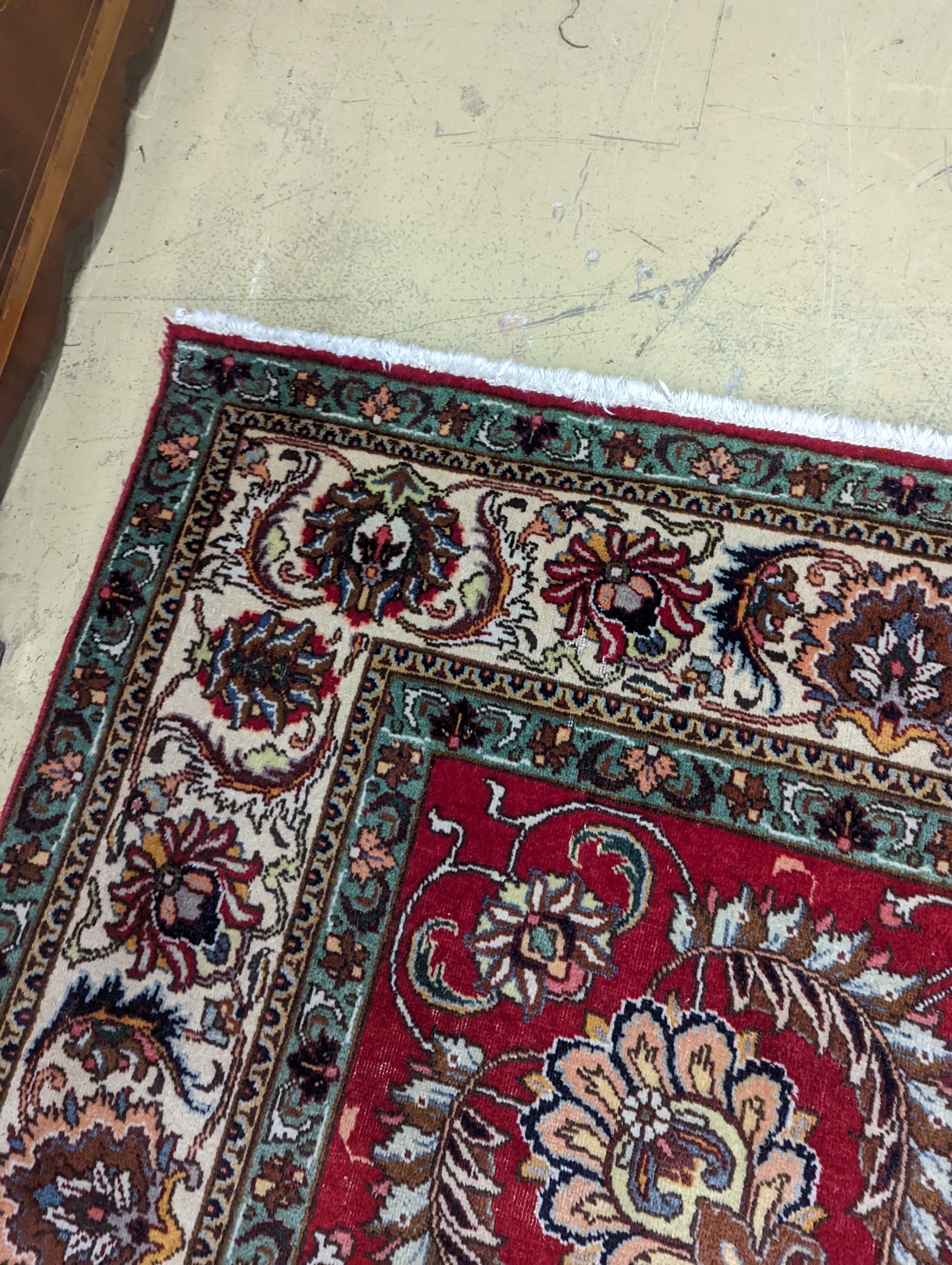 A Tabriz red ground carpet, 400 x 290cm